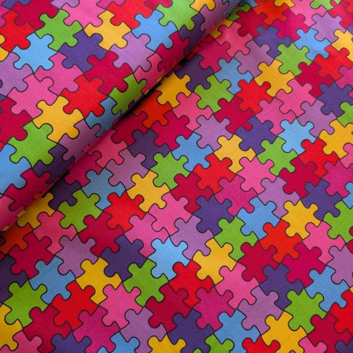 Multicolour Autism Awareness puzzle piece cotton fabric with red, blue, green, yellow, and purple jigsaw pattern