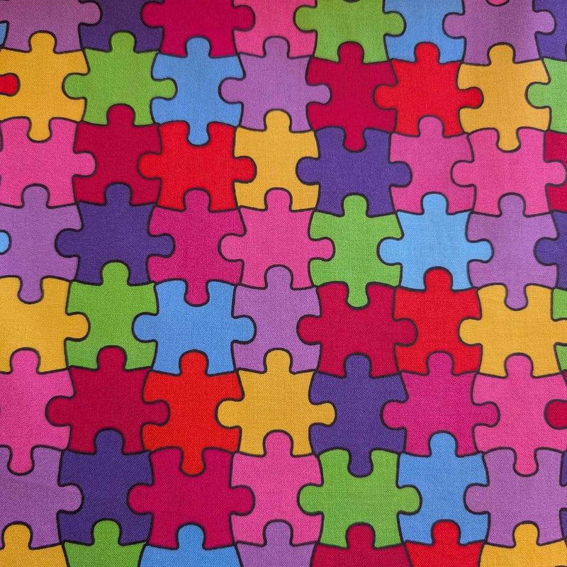 Multicolour Autism Awareness puzzle piece cotton fabric with red, blue, green, yellow, and purple jigsaw pattern