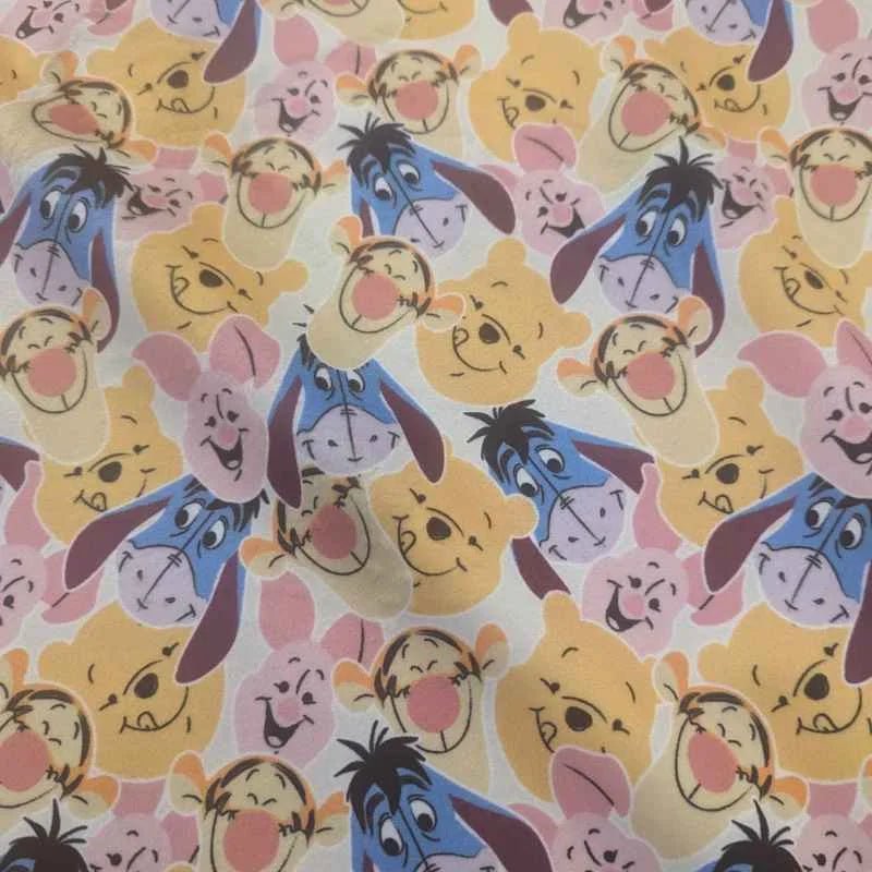 Cream minky fabric with Winnie the Pooh, Piglet, Tigger, and Eeyore faces in an allover print – Camelot brand