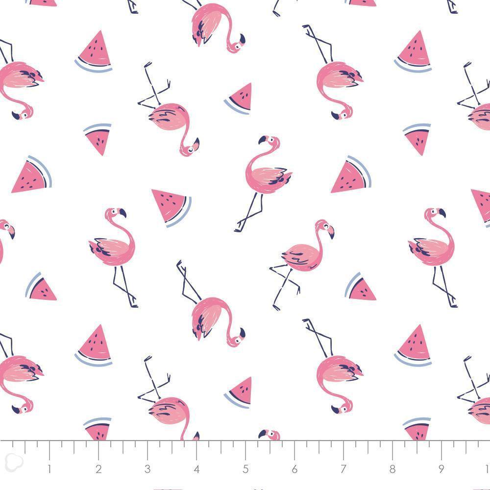 White cotton fabric with pink flamingos and watermelon slice pattern, novelty quilting fabric with ruler for scale.