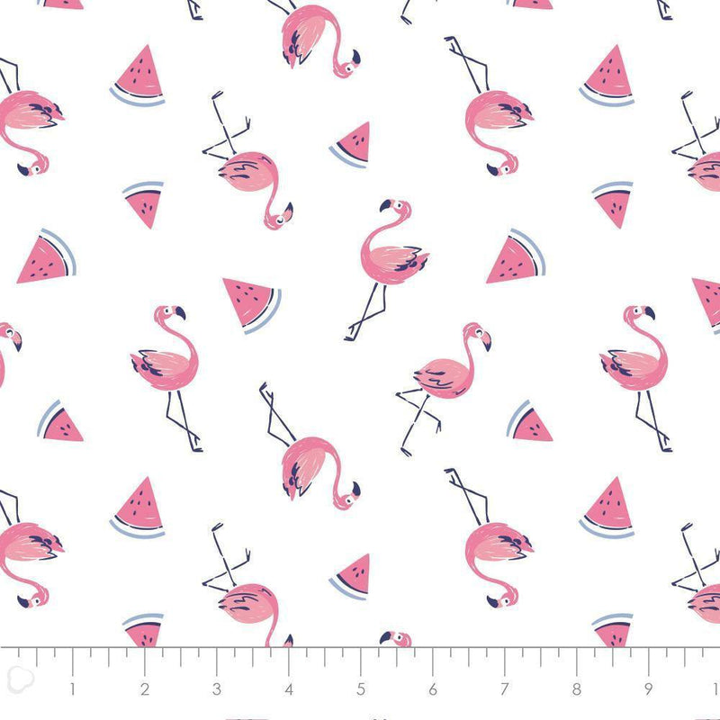 White cotton fabric with pink flamingos and watermelon slice pattern, novelty quilting fabric with ruler for scale.