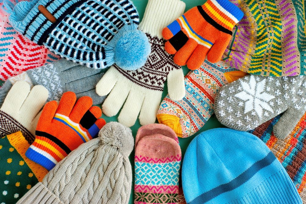 Choosing the Best Winter Fabrics from Your Online Fabric Store. A lot of hats, gloves, mittens. Warm clothes in the form of knitted hats, mittens, gloves, scarves for the cold seasons. Multi-colored clothes for autumn and winter.