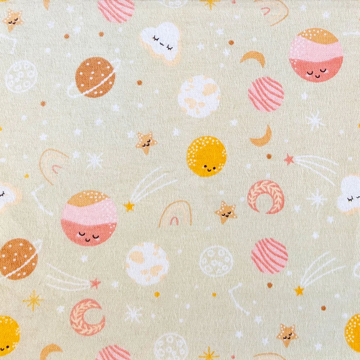 Camelot Fabrics Space Friends pink cotton flannel fabric featuring smiling planets, stars, moons, clouds, and rainbows from the Fleece and Flannel 2026 Collection.