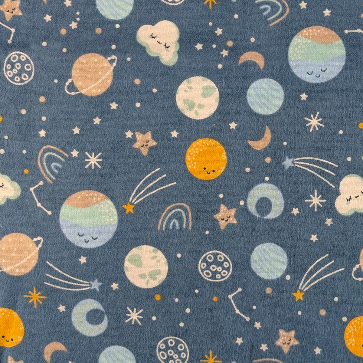 Camelot Fabrics Space Friends navy cotton flannel fabric featuring pastel planets, stars, moons, constellations, and shooting stars from the Fleece and Flannel 2026 Collection.