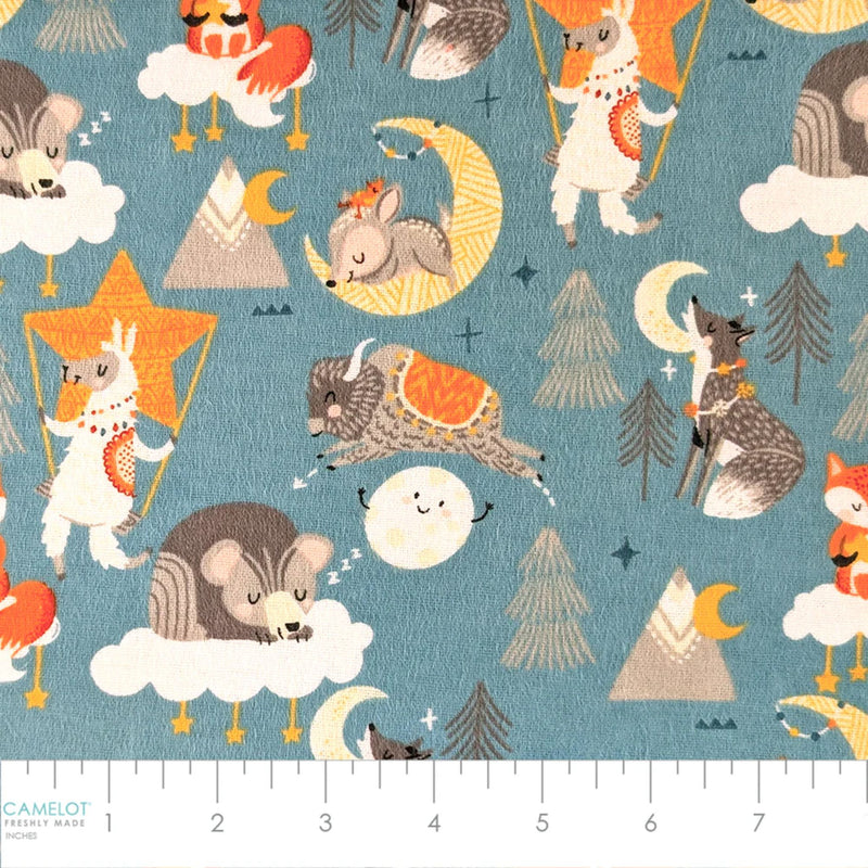 Desert Baby teal cotton flannel fabric featuring foxes, llamas, wolves, rabbits, buffalo, bears, mountains, moons, clouds, and stars.