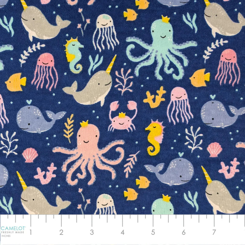 Ocean Baby navy cotton flannel fabric featuring whales, narwhals, octopuses, jellyfish, seahorses and sea life.