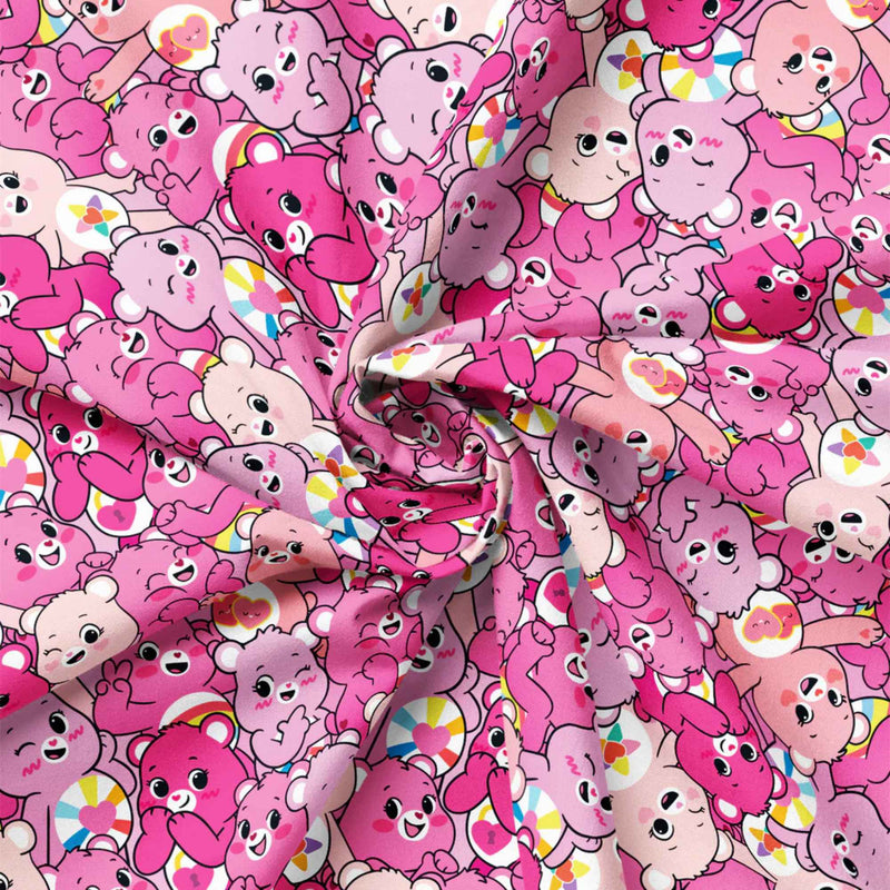 “Licensed pink Care Bears cotton fabric featuring a repeating pattern of cheerful pink and blush Care Bears in cute, playful poses.”
