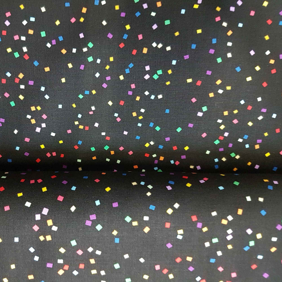 Black cotton fabric with multicolored confetti square print from Celebrate Good Times by Hoffman California Fabrics.