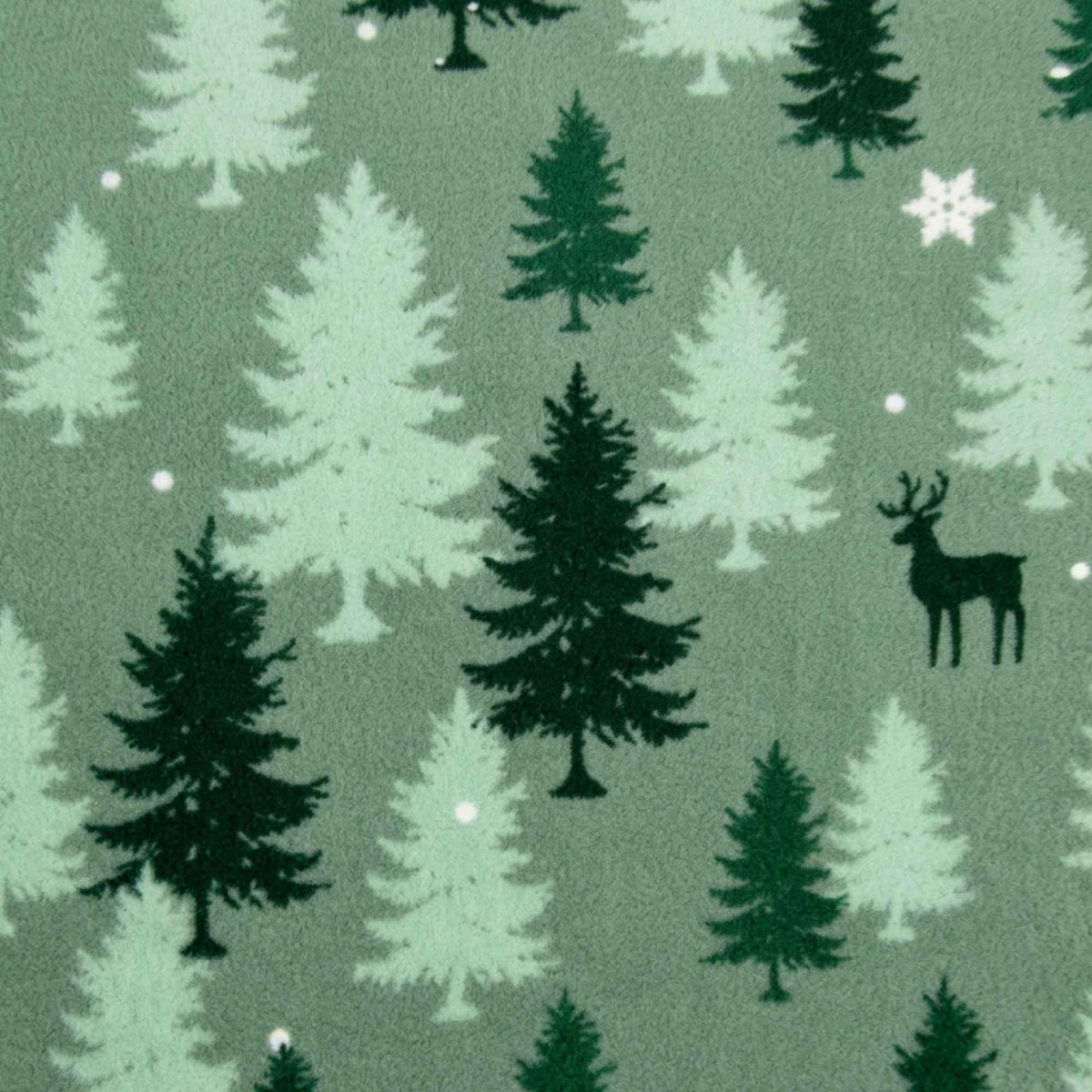 Double brushed flannel fabric featuring evergreen trees, deer silhouettes, snowflakes, and falling snow on a sage green background.
