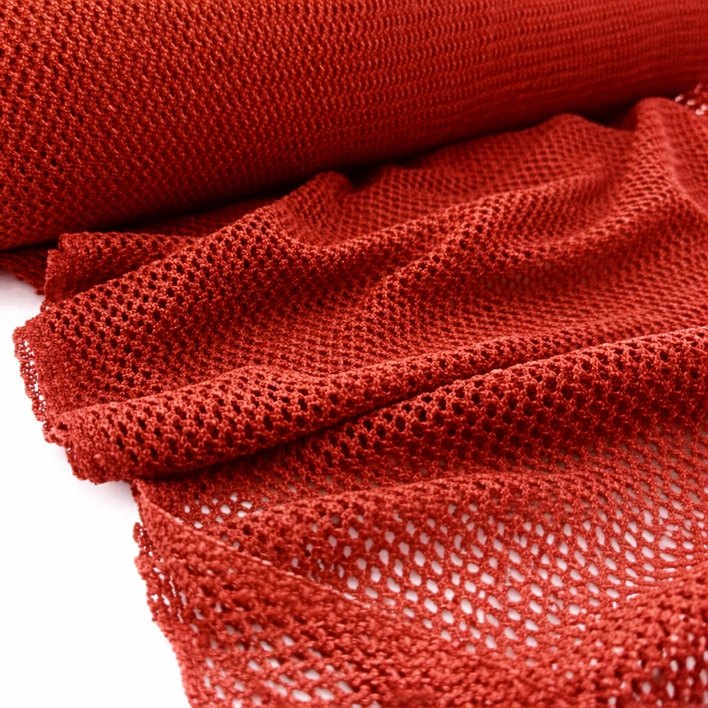 Paprika fish net mesh fabric showing breathable open knit texture in warm red orange tone