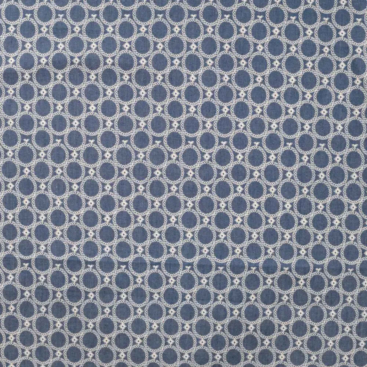 Blue chambray cotton fabric with white geometric circle print lightweight woven fabric for apparel quilting and sewing projects