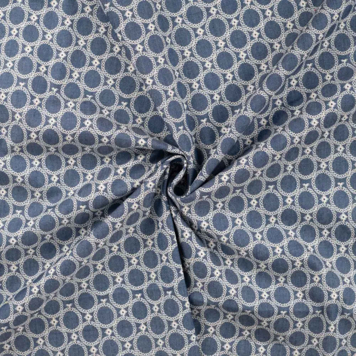 Blue chambray cotton fabric with white geometric circle print lightweight woven fabric for apparel quilting and sewing projects