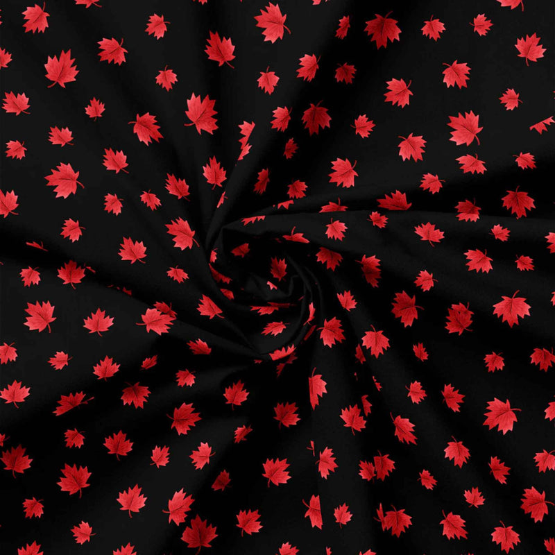 "Black cotton fabric with scattered red maple leaf pattern from Camelot Fabrics"