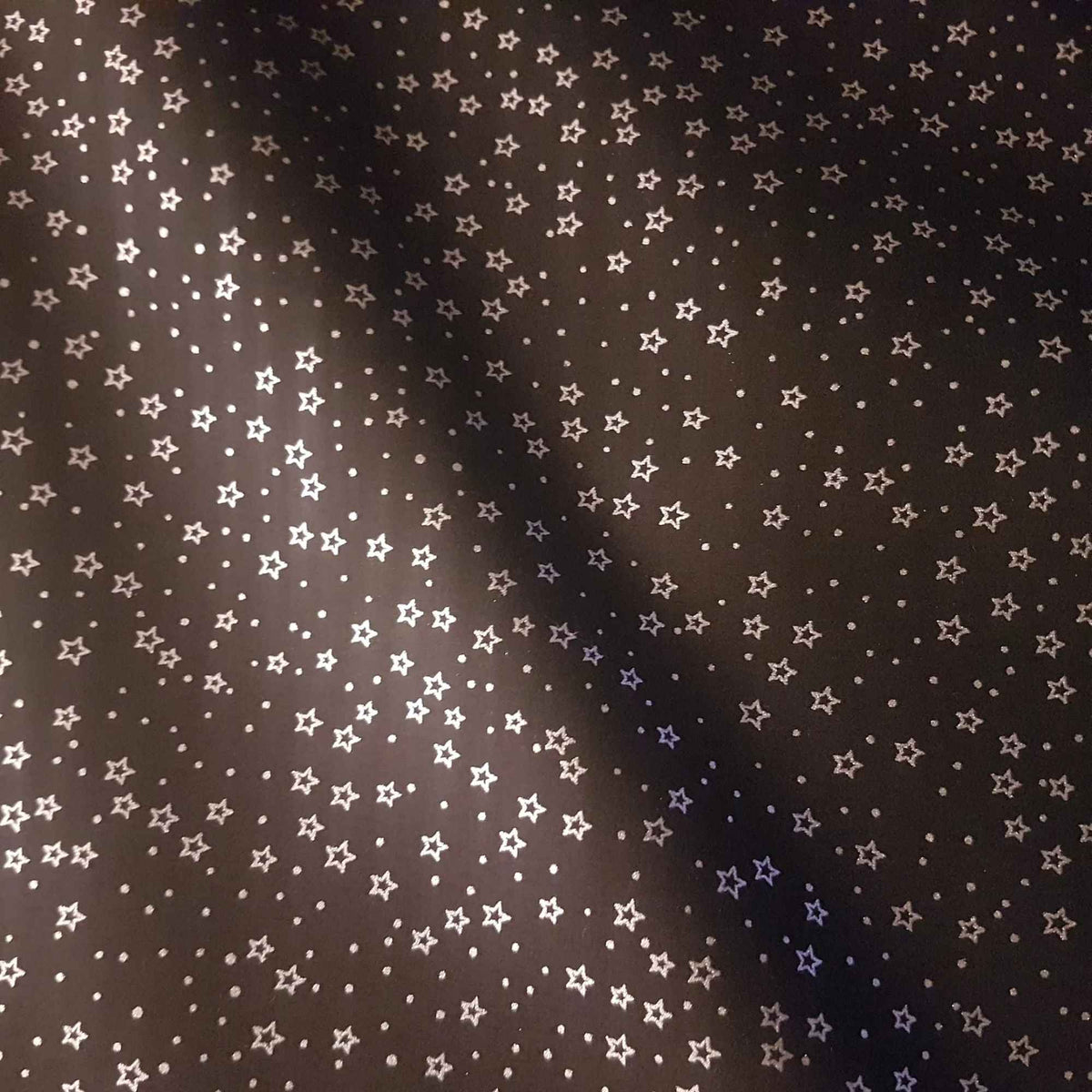 Black cotton fabric with metallic silver stars scattered across.