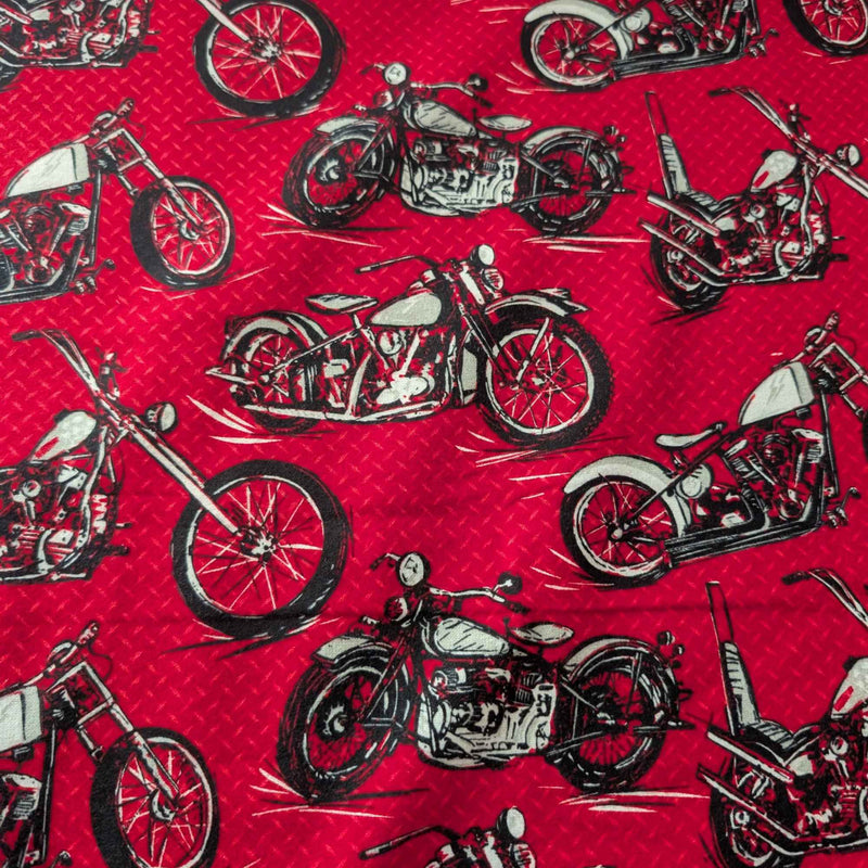 Red cotton flannel fabric with black and grey motorcycle print, brushed soft, OEKO-TEX certified, 44 inches wide.