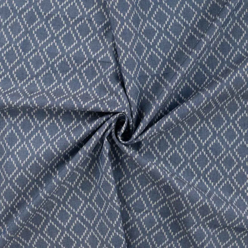 Blue chambray cotton fabric with white geometric diamond pattern lightweight woven fabric for apparel quilting and sewing projects