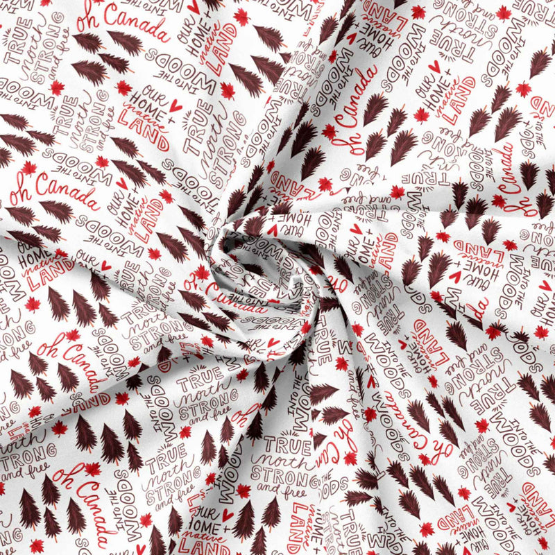 "Strong and Free Canadian text cotton fabric with maple leaves and pine trees on white by Camelot Fabrics"