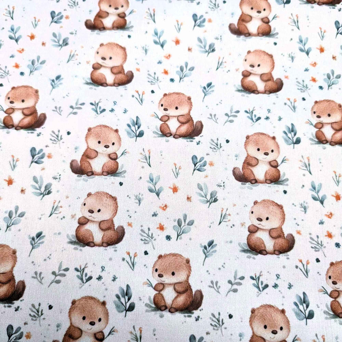 Woodland beaver waterproof PUL fabric with soft brown beavers and green leaves on a neutral background