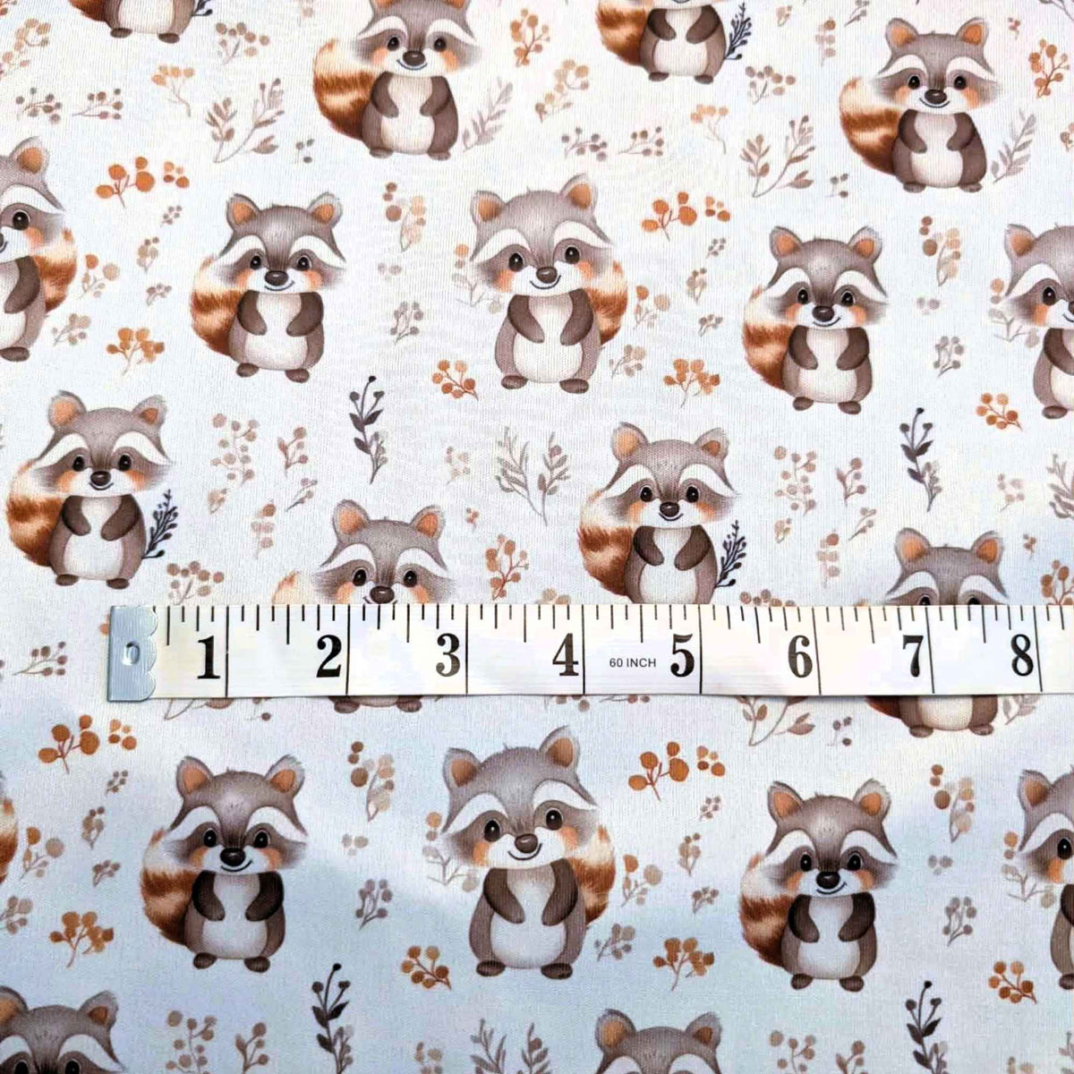 Woodland raccoon PUL fabric showing print scale waterproof sewing fabric