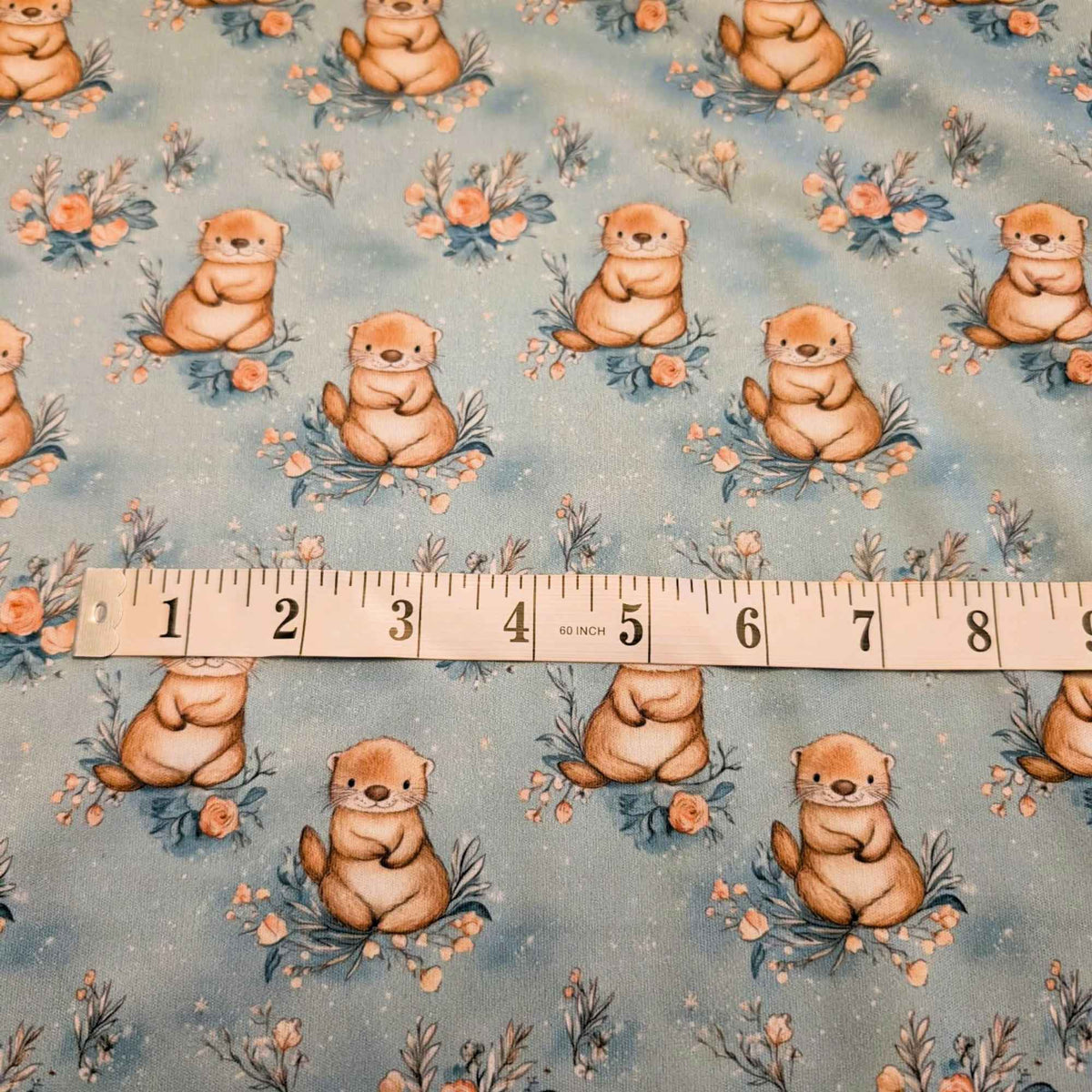 Otter on teal PUL fabric showing print scale waterproof sewing fabric