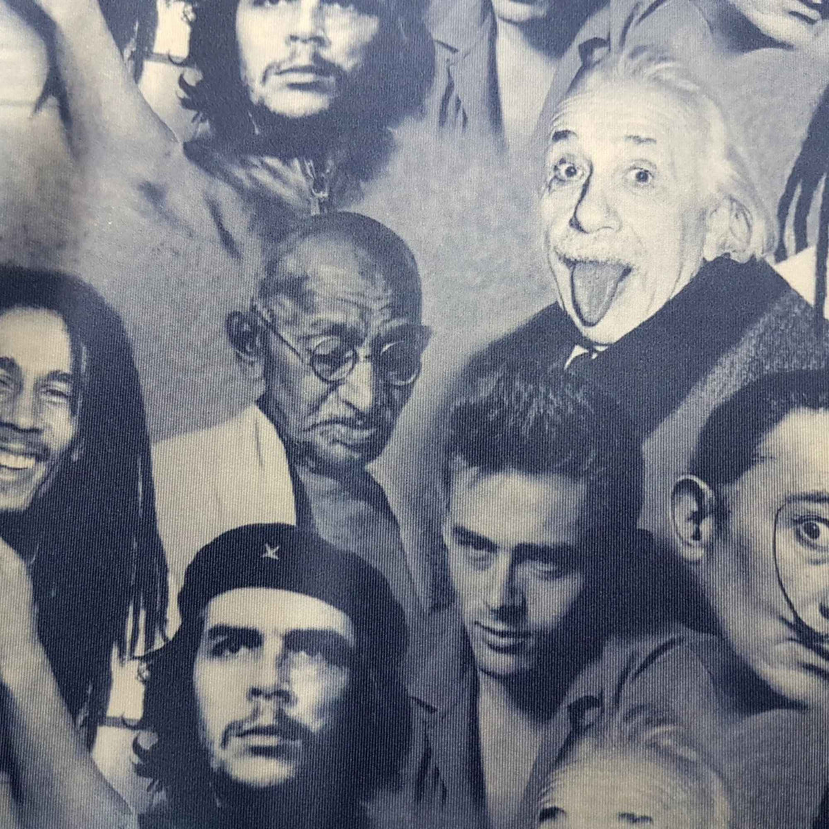 Blue grey polyester spandex fabric featuring portraits of Albert Einstein, Bob Marley, and other iconic figures in a repeating print