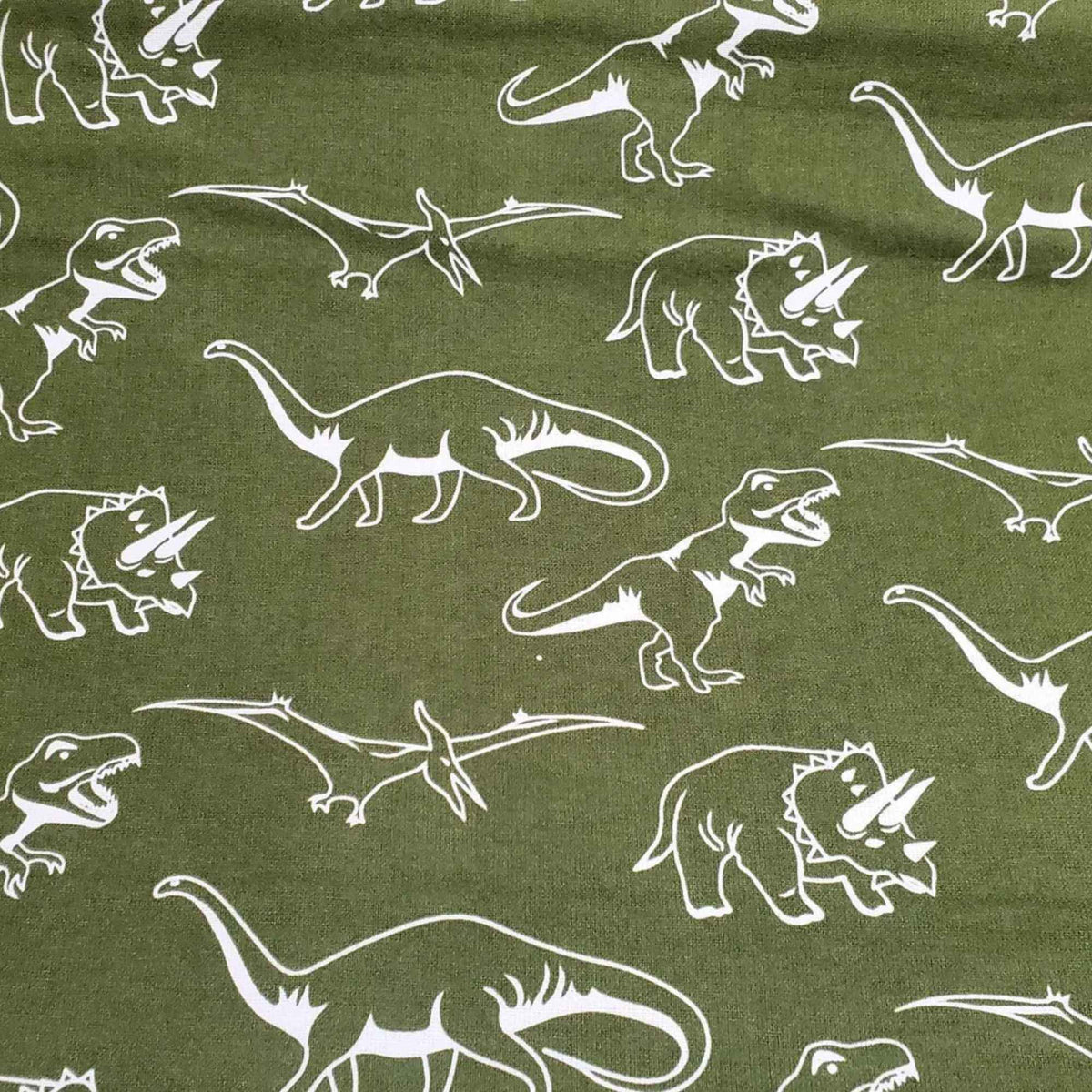 Glow in the dark dinosaur cotton flannel fabric with white dinosaur silhouettes on dark background, soft brushed quilting fabric