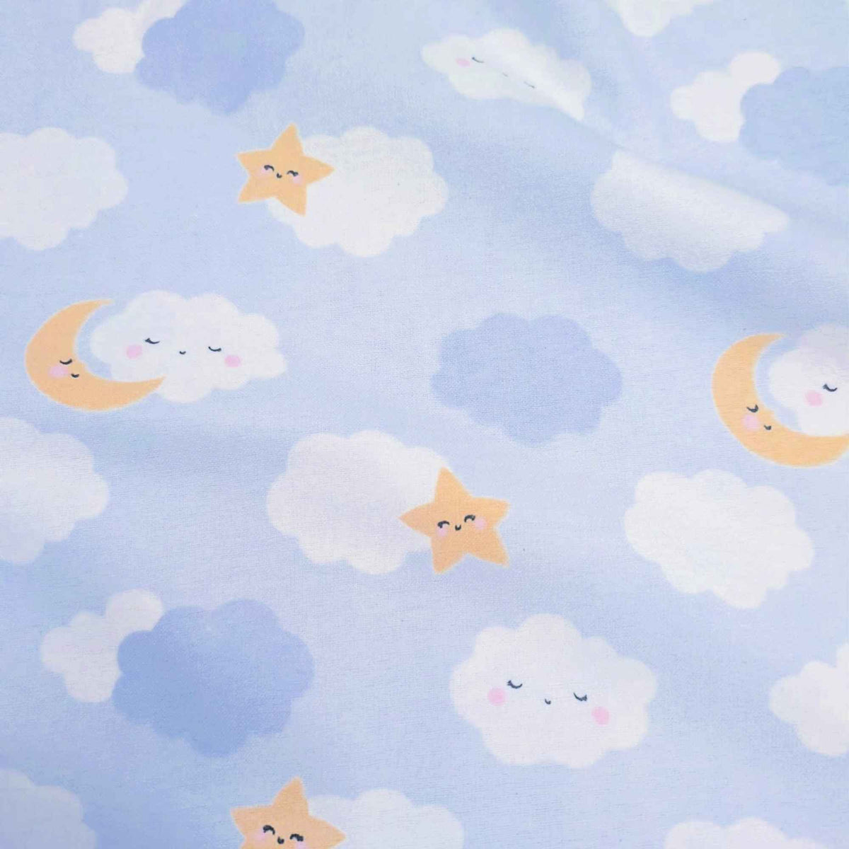 Light blue fabric with a cute celestial pattern featuring smiling yellow stars, crescent moons, and fluffy white and blue clouds.