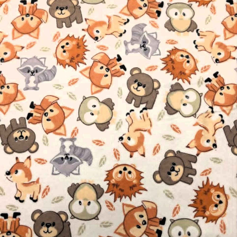 Double brushed flannel fabric featuring foxes, owls, bears, raccoons, deer, and hedgehogs on a cream woodland background.