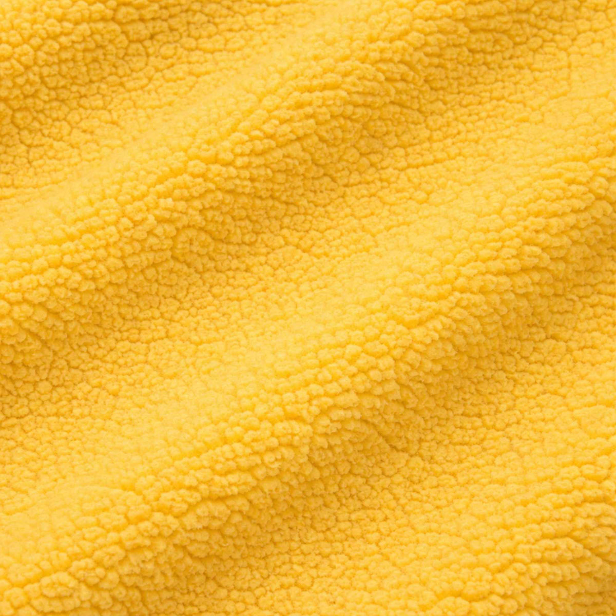 Bright yellow anti-pill polar fleece fabric close-up showing soft plush texture