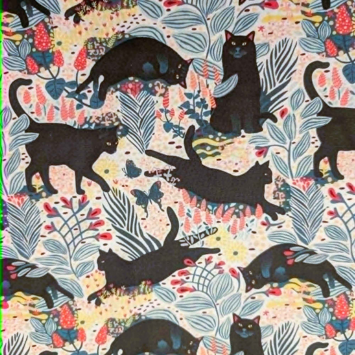Black cat floral novelty quilting cotton fabric with leaves and butterflies on a light background