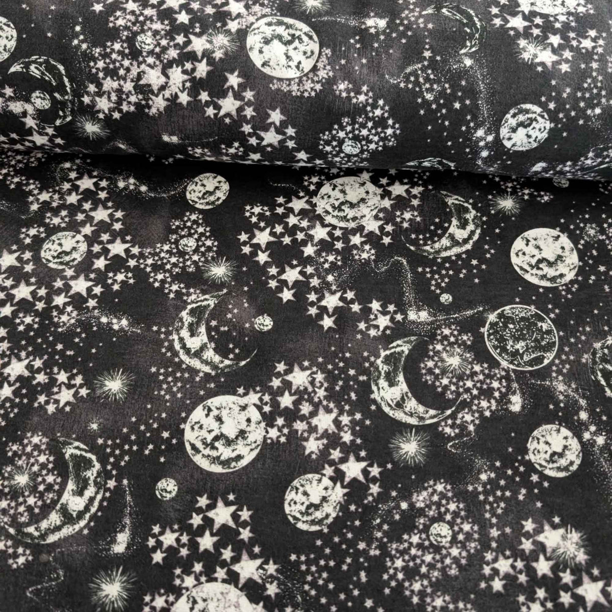 Constellation cotton flannel fabric with moon and stars pattern on dark background, soft brushed quilting fabric