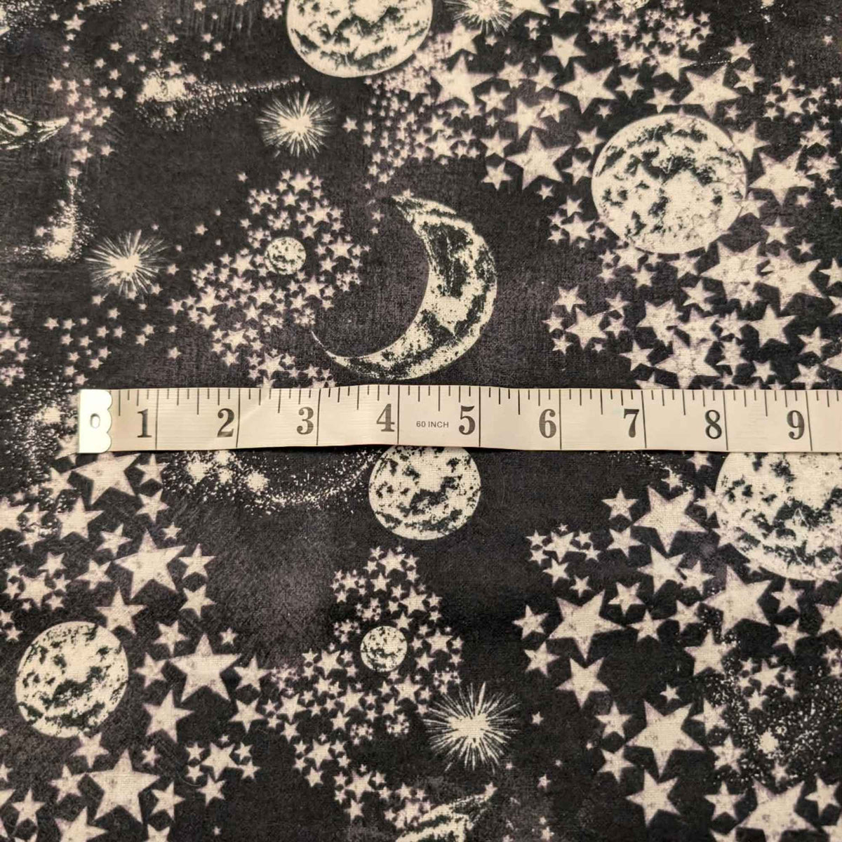 Constellation cotton flannel fabric with moon and stars pattern on dark background, soft brushed quilting fabric