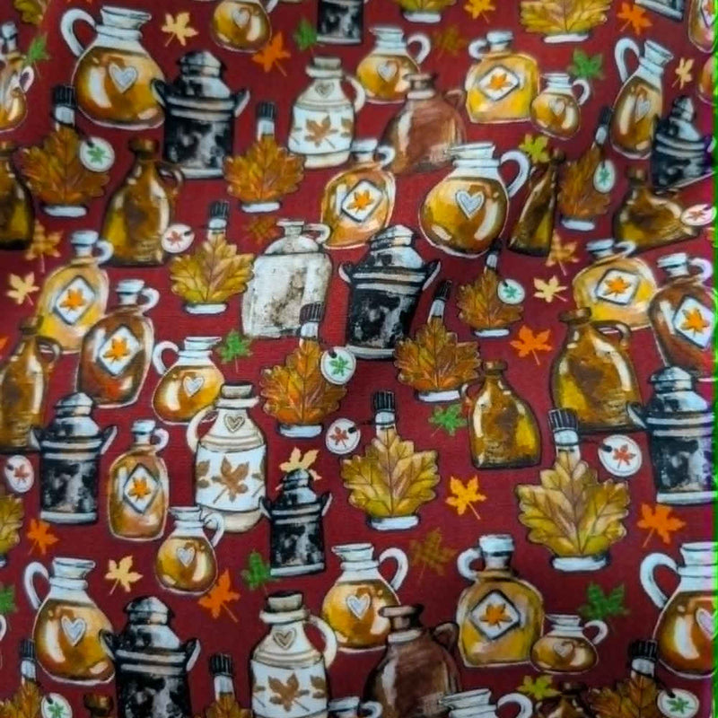 Autumn maple syrup jugs and fall leaves cotton fabric on red background with rustic harvest theme
