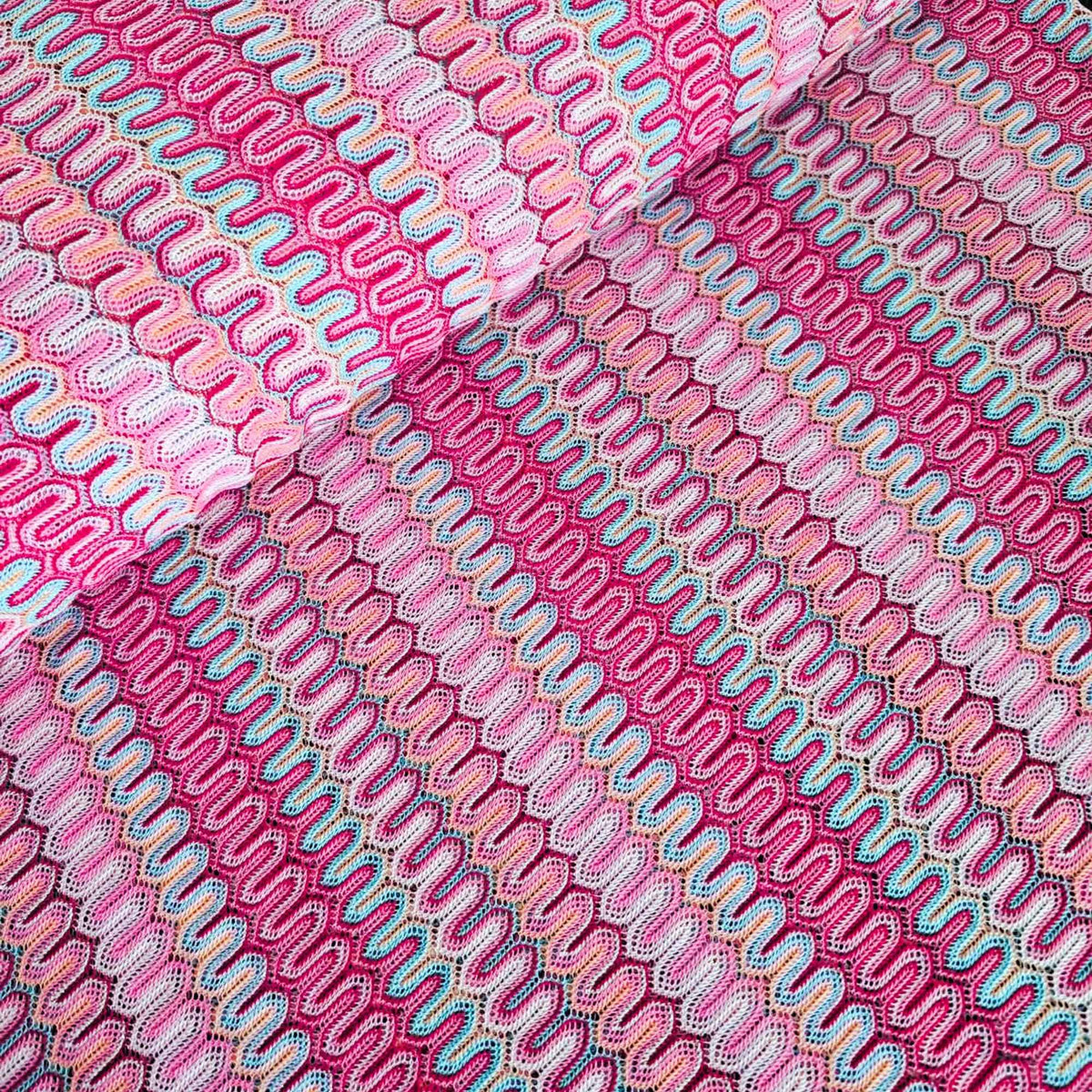 Missoni style pink zigzag wave stretch jersey knit fabric with fuchsia ivory and aqua pattern close-up texture