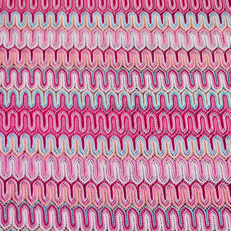Missoni style pink zigzag wave stretch jersey knit fabric with fuchsia ivory and aqua pattern close-up texture
