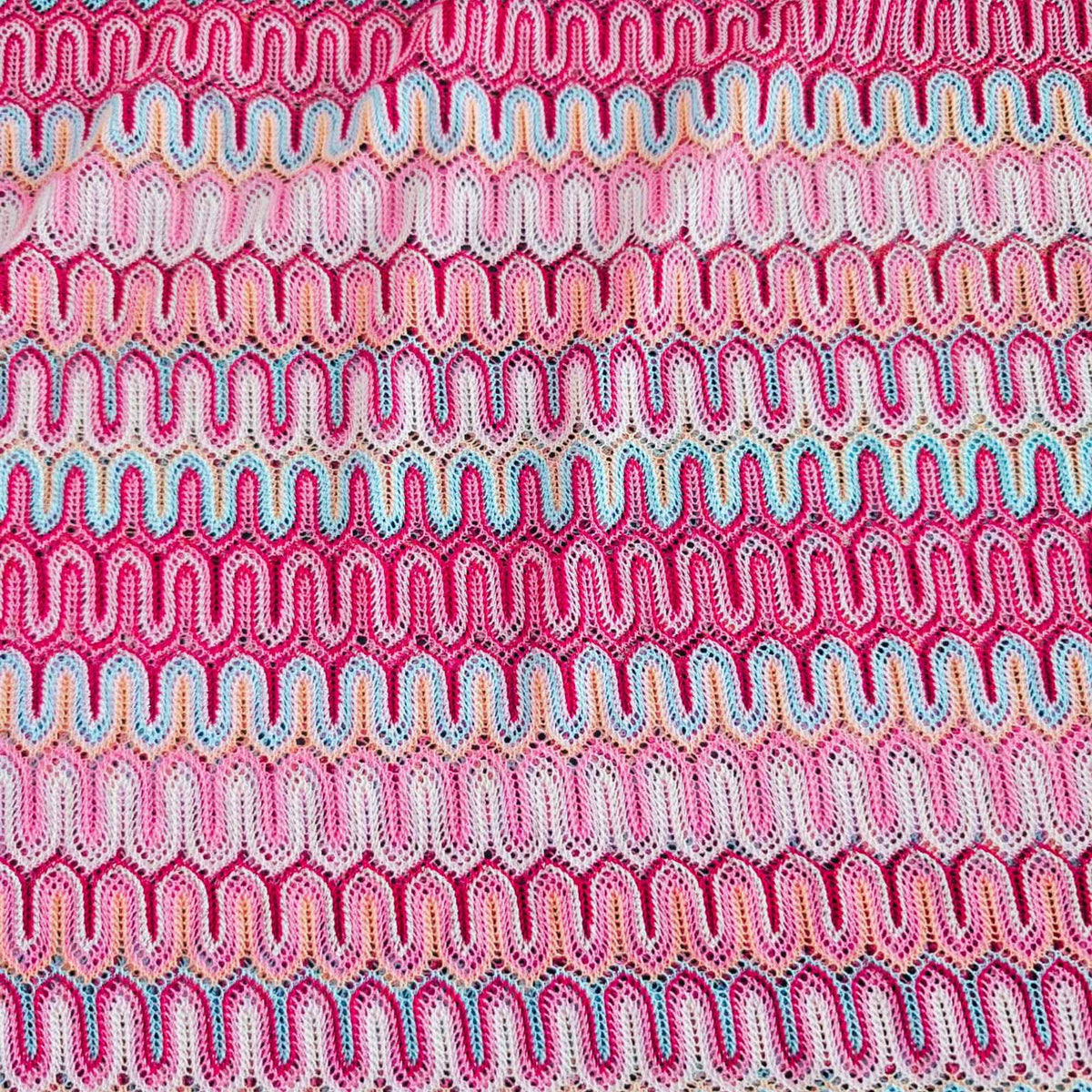 Missoni style pink zigzag wave stretch jersey knit fabric with fuchsia ivory and aqua pattern close-up texture