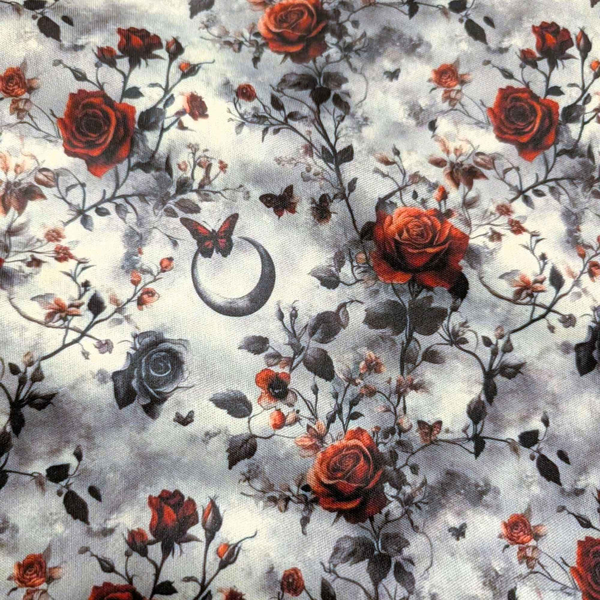 Enchanted Moonlit Roses exclusive waterproof PUL fabric with red and black roses, butterflies and crescent moons on a smoky cream background