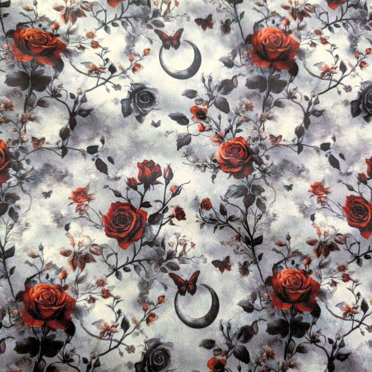 Enchanted Moonlit Roses exclusive waterproof PUL fabric with red and black roses, butterflies and crescent moons on a smoky cream background