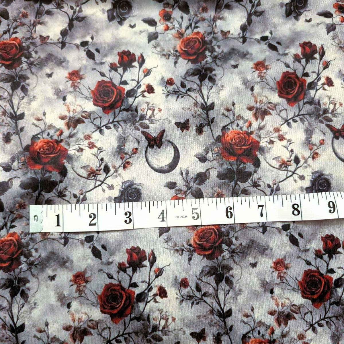Enchanted Moonlit Roses exclusive waterproof PUL fabric with red and black roses, butterflies and crescent moons on a smoky cream background
