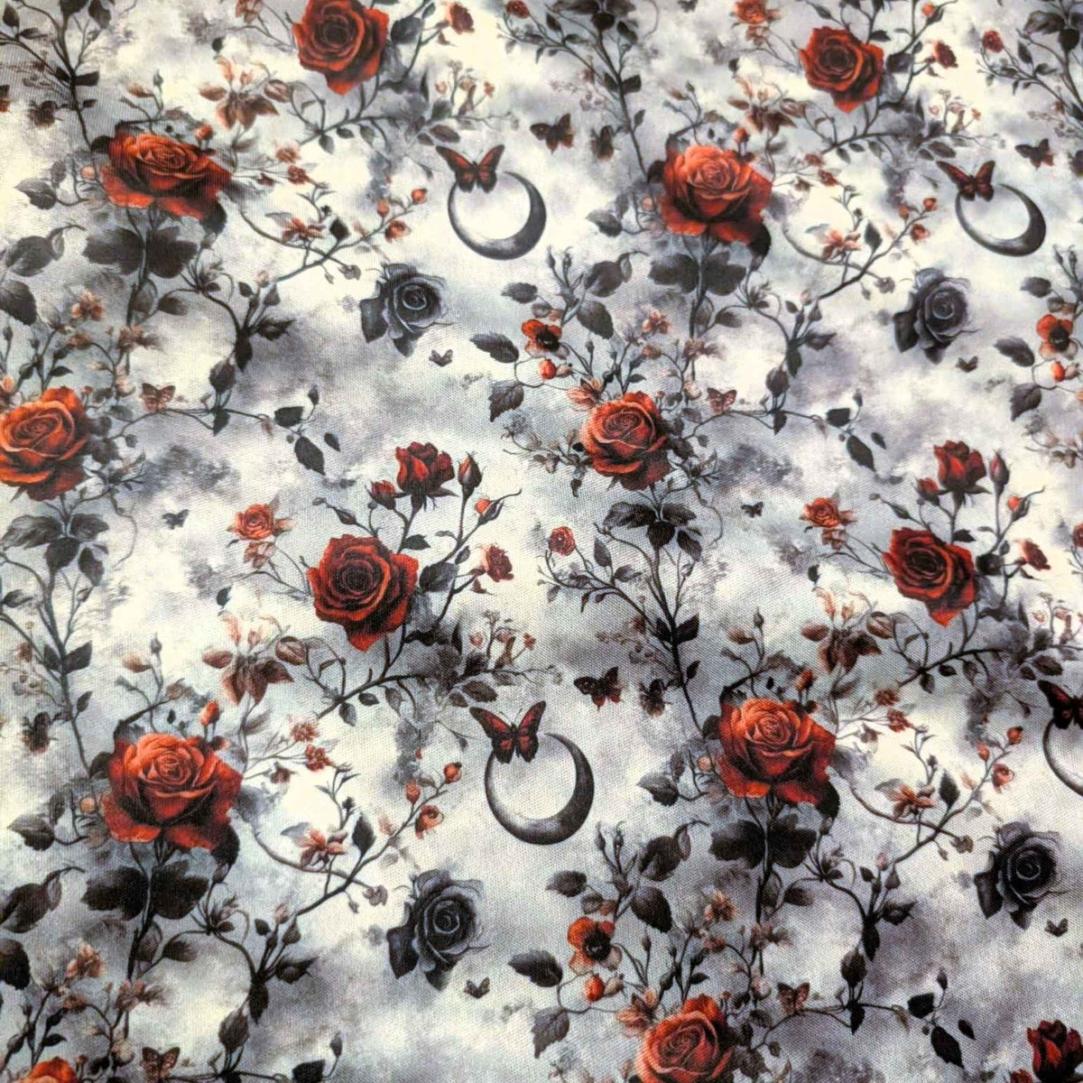 Enchanted Moonlit Roses exclusive waterproof PUL fabric with red and black roses, butterflies and crescent moons on a smoky cream background
