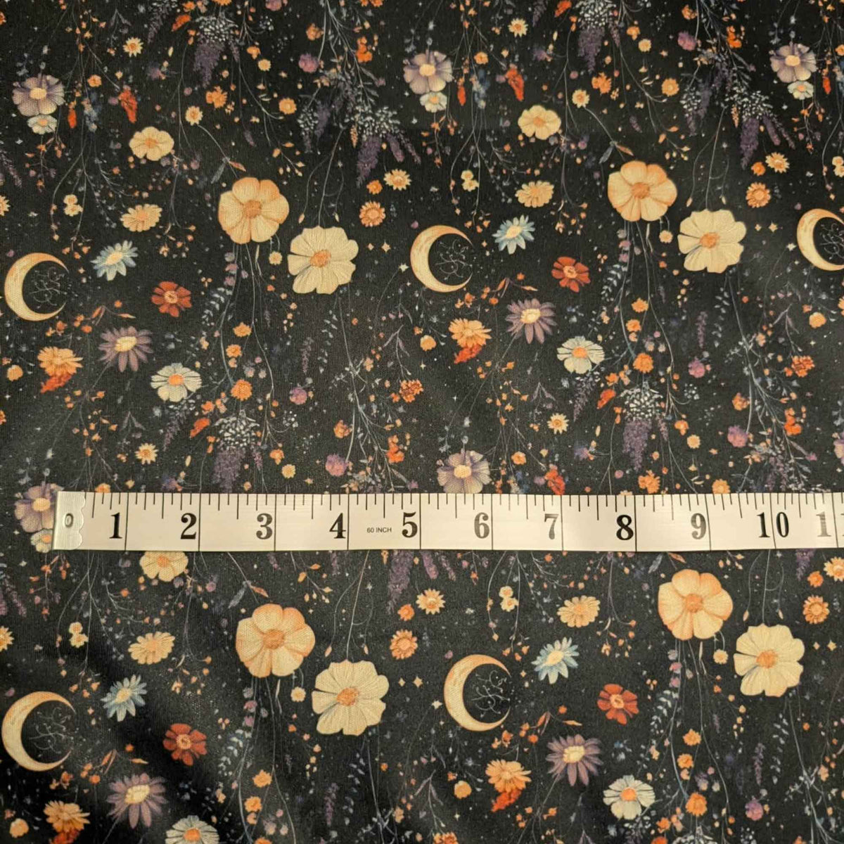 Moonlit Wildflower Garden exclusive waterproof PUL fabric with golden crescent moons and colourful wildflowers on a black background