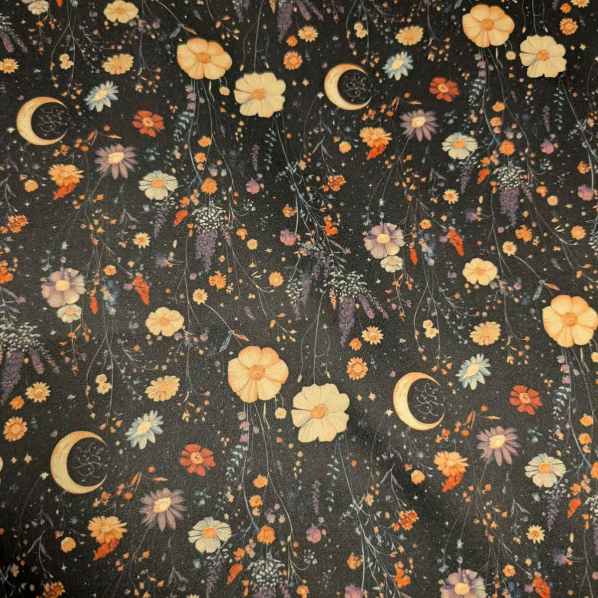 Moonlit Wildflower Garden exclusive waterproof PUL fabric with golden crescent moons and colourful wildflowers on a black background