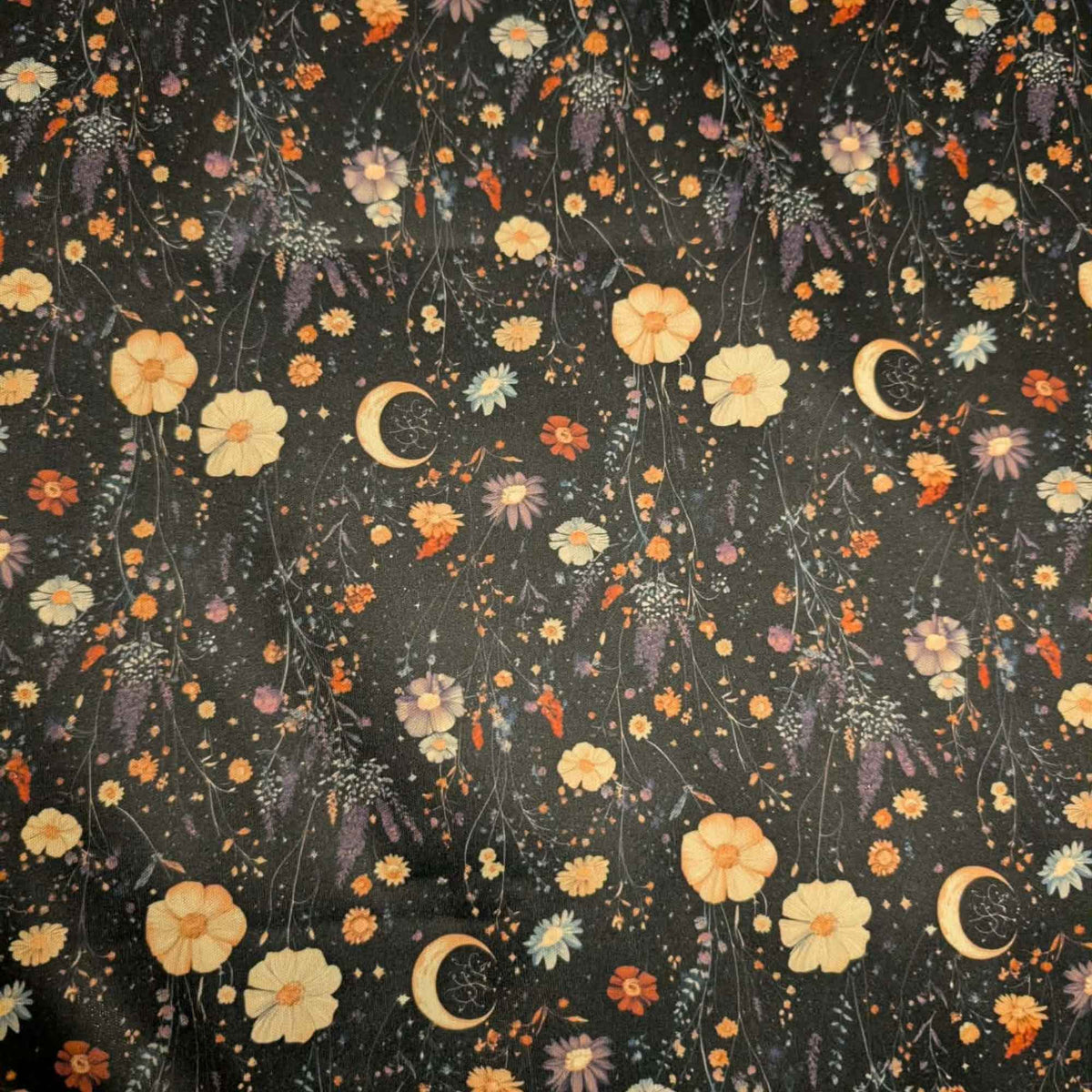 Moonlit Wildflower Garden exclusive waterproof PUL fabric with golden crescent moons and colourful wildflowers on a black background