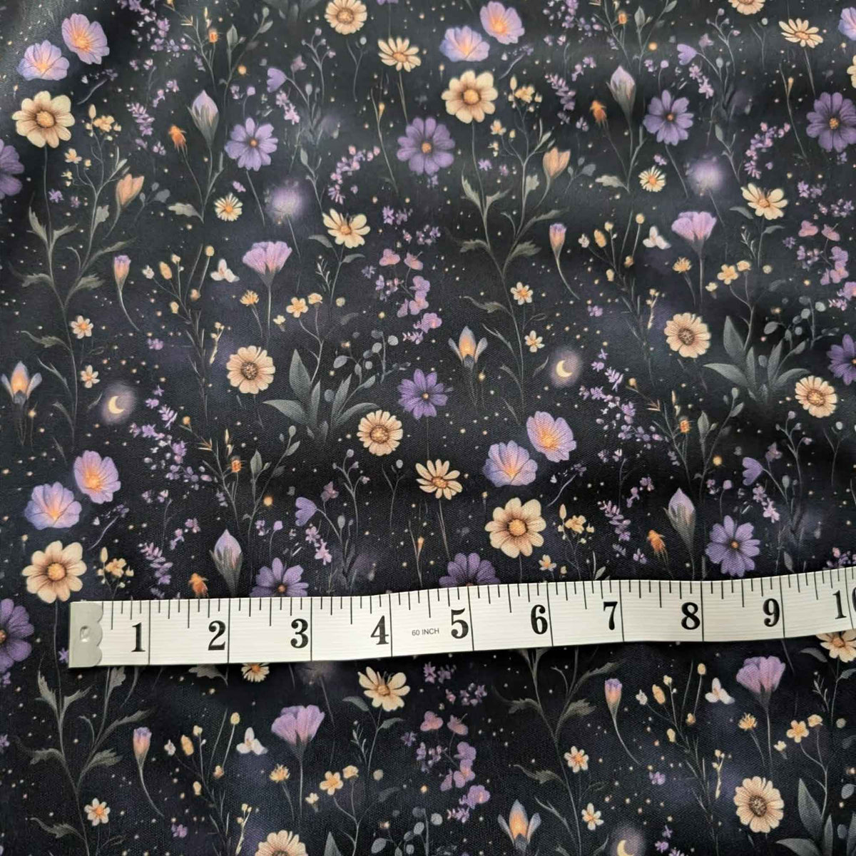 Starlit Wildflower Meadow exclusive waterproof PUL fabric with purple and golden flowers, crescent moons and glowing stars on black