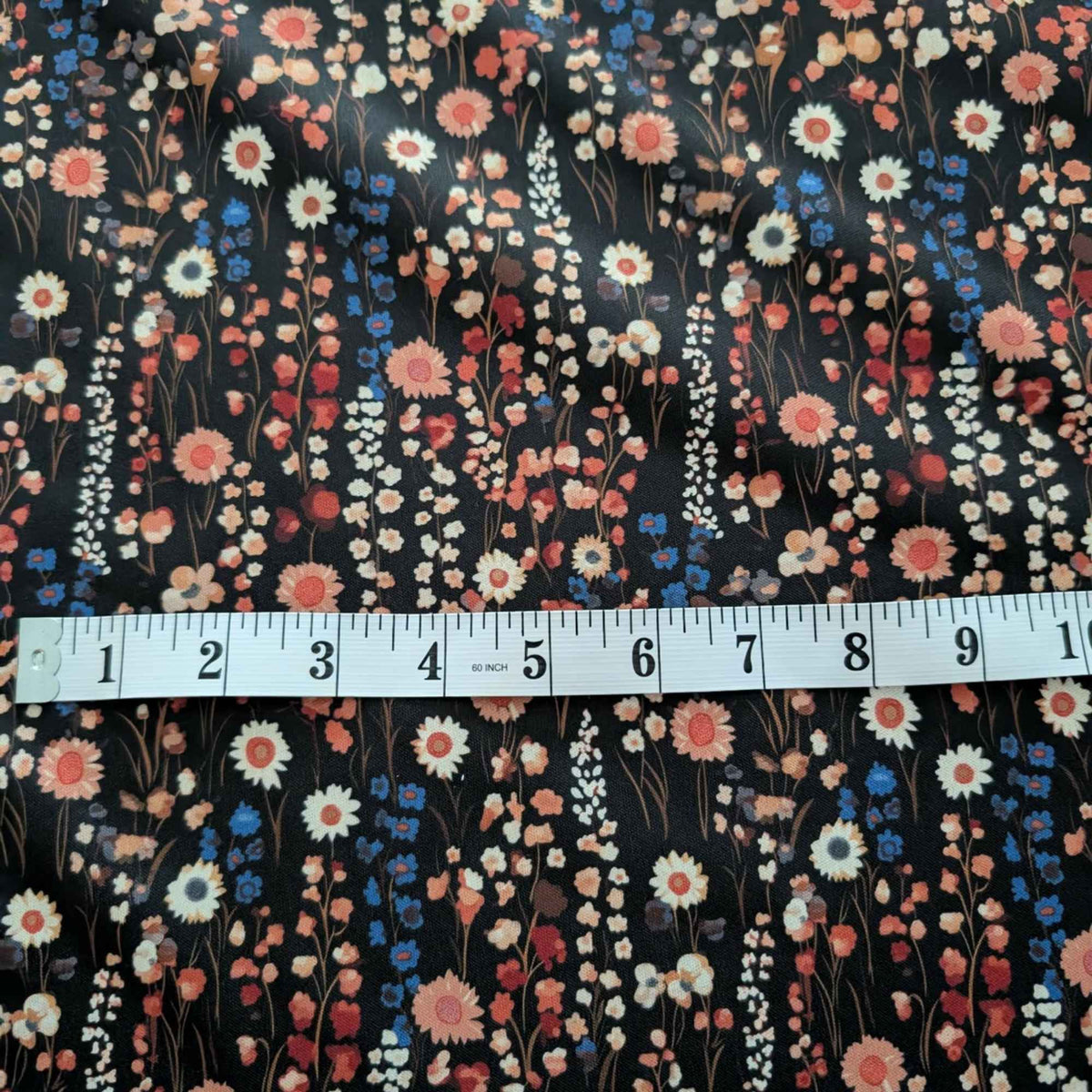 Vintage Wildflower Meadow exclusive waterproof PUL fabric with coral, cream and blue flowers on a black background