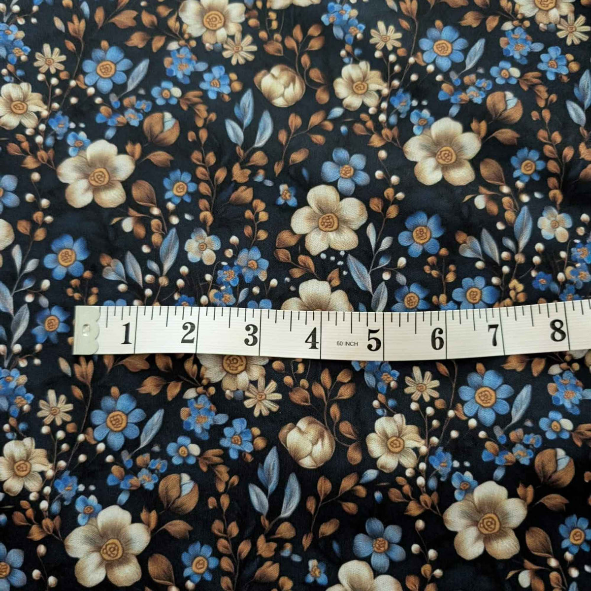 Midnight Blue Botanical Garden exclusive waterproof PUL fabric with blue and ivory flowers and bronze leaves on a dark background