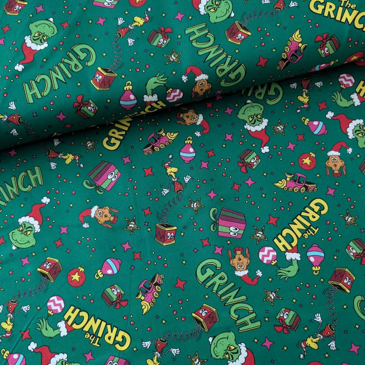Grinch Toy Toss Christmas cotton fabric on evergreen by Robert Kaufman