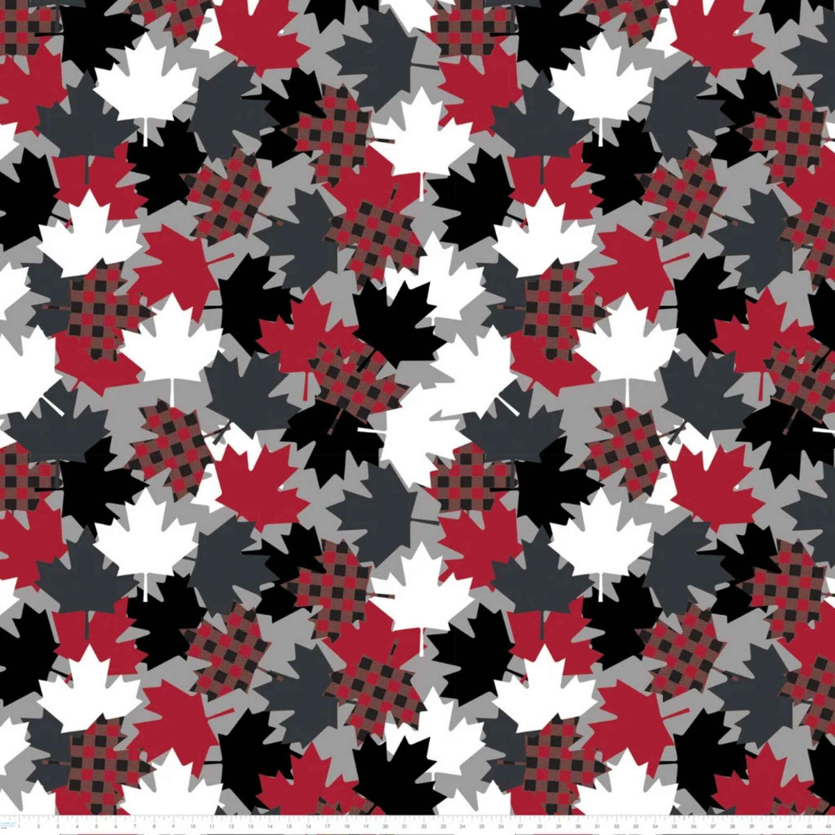 Maple Leaves fleece by Camelot with overlapping red, black, grey and white leaves, including red and black plaid maple leaves with ruler for scale.