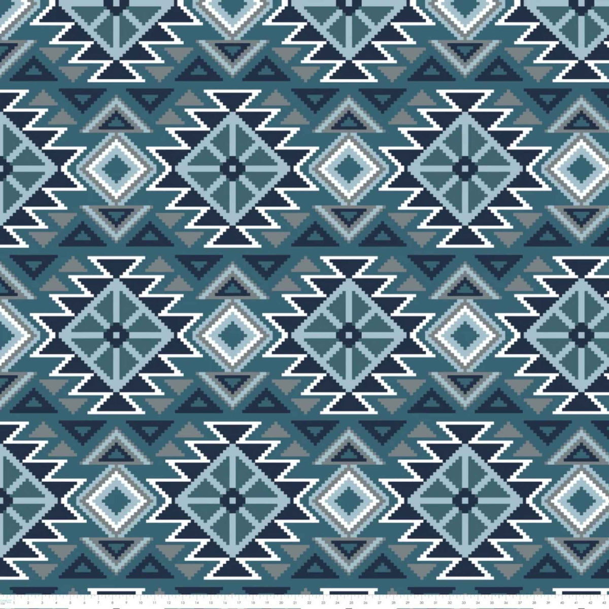 To the Mountains denim blue fleece by Camelot with navy, pale blue, grey and white geometric diamonds, triangles and zigzags with ruler for scale.