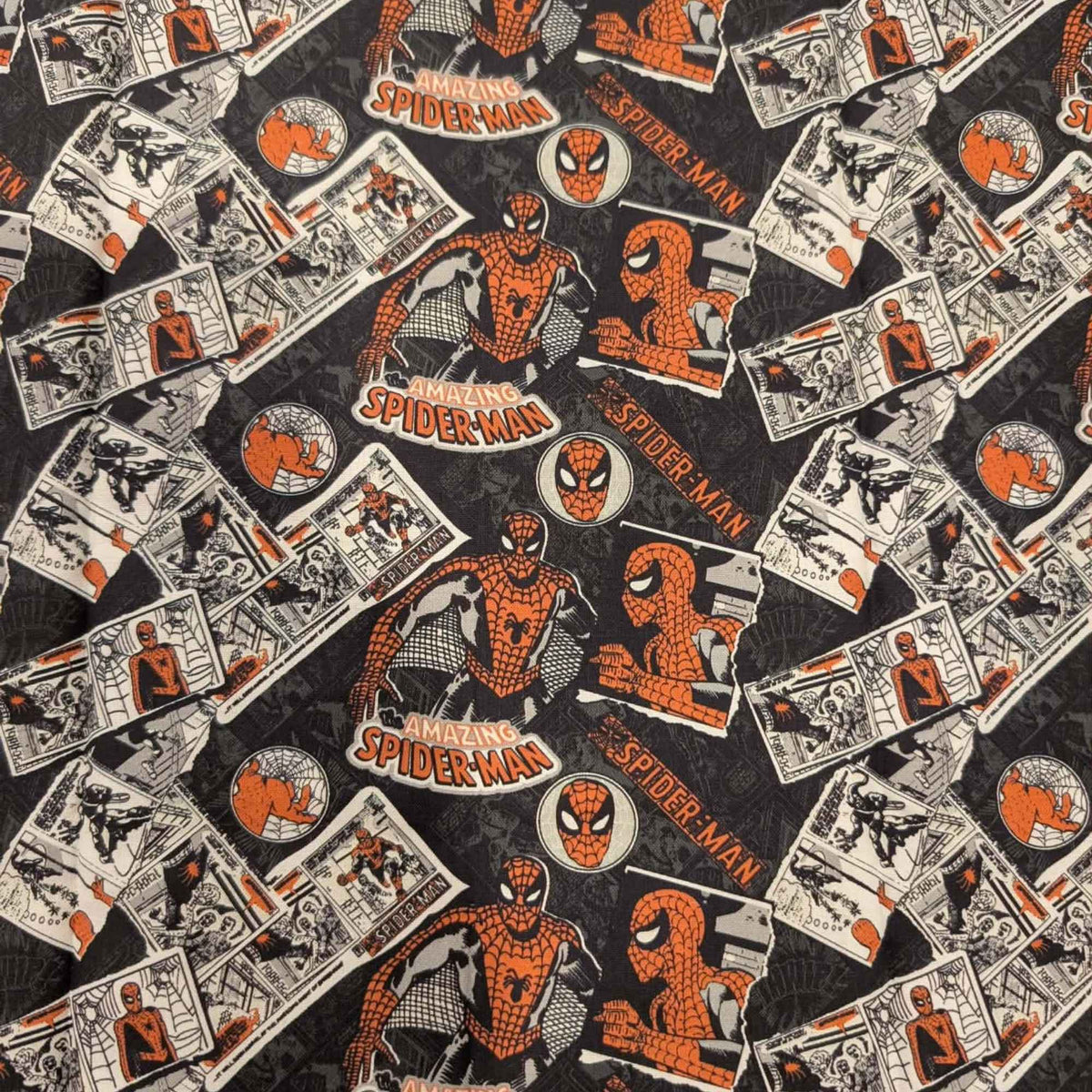 Marvel Amazing Spider-Man comic collage quilting cotton fabric featuring vintage comic panels, Spider-Man logos, character artwork, and mask icons on a black background.